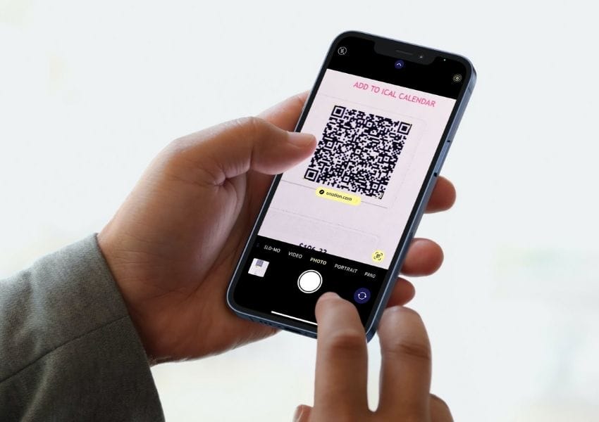 Person scanning a UNATION ticket with a mobile phone