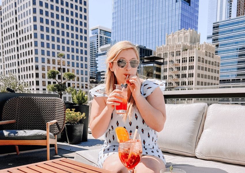 Girl drinking at a rooftop bar in downtown Austin called Las Bis